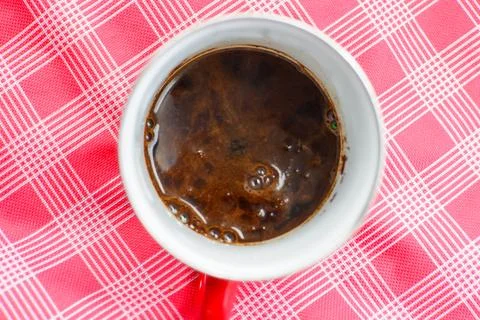 Texture of coffee in a red cup at a camping location Stock Photos