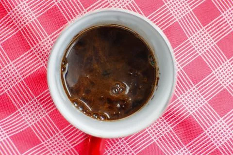 Texture of coffee in a red cup at a camping location Stock Photos