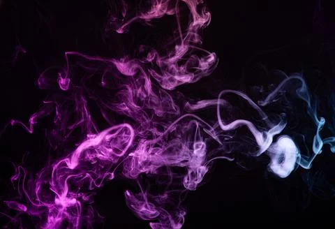 Texture of colored smoke on a black background . Stock Photos