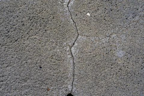 Texture of concrete with a crack in the middle. Close-up. Inclusions of sand  Stock Photos