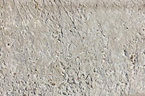 Texture of concrete featuring small holes and irregular surface, ideal for de Stock Photos