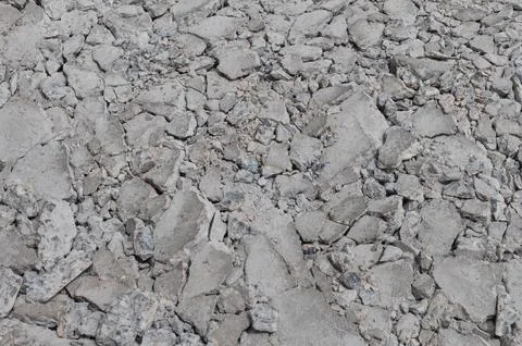 Texture of concrete road cracks on construction site background Stock Photos