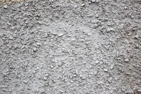 The texture of the concrete wall part with a small crumb of stone. Grey Textured Stock Photos