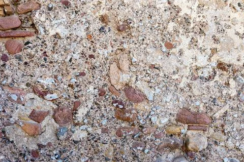 Texture of a concrete wall with pebbles Stock Photos