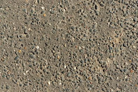 Texture of a concrete wall with small splashes of gravel 스톡 사진