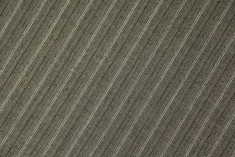 The texture of the costume fabric, diagonal pattern, neutral color. Stock Photos