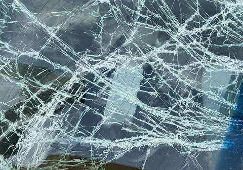 Texture of a cracked car windshield. broken glass dark background Stock Photos