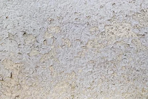 Texture of cracked gray paint on an old weathered wall. Dirty peeling paint. Stock Photos