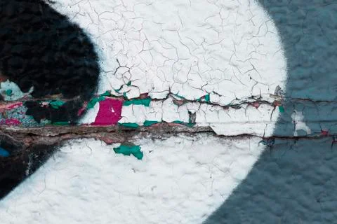 The texture of cracked paint in several multi-colored layers was shot close-up Stock Photos