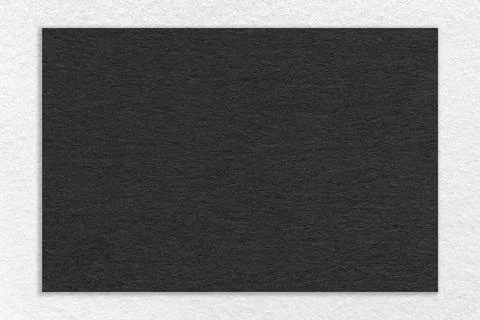 Texture of craft black paper background with white border, macro. Stock Photos