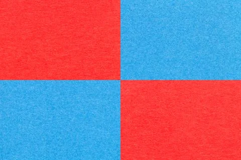 Texture of craft bright red and blue paper background with cells pattern. Stock Photos