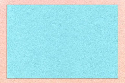 Texture of craft light blue color paper background with pink border, macro. Stock Photos