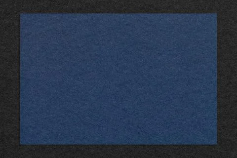 Texture of craft navy blue color paper background with black border, macro. Stock Illustration