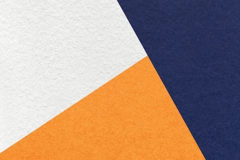 Texture of craft navy blue, white and orange shade color paper background Stock Photos