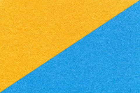 Texture of craft yellow and light blue paper background, half two colors Stock Photos