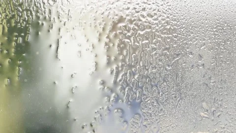 Texture created by water on a glass, drops of water running down a window Stock Footage 238439299