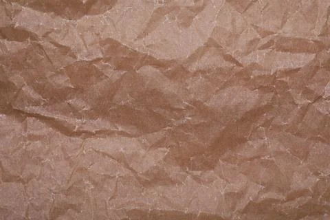 Texture of crumpled brown baking paper as background, top view Stock Photos