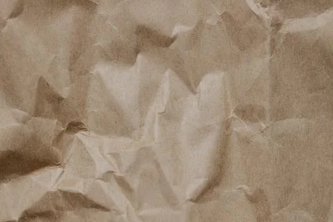 The texture of crumpled craft paper. Background. Close-up. Stock Photos