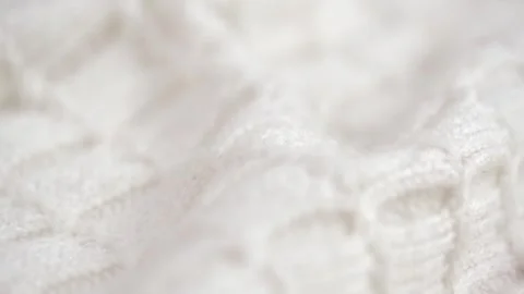 Texture of crumpled knitted woolen clothes with pattern closeup. rotation. macro Stock Footage 242760752