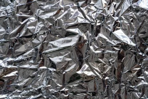 Texture of crumpled silver foil plastic. Stock Photos