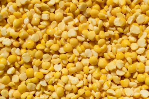 Texture of crushed yellow peas close-up, food background Stock Photos