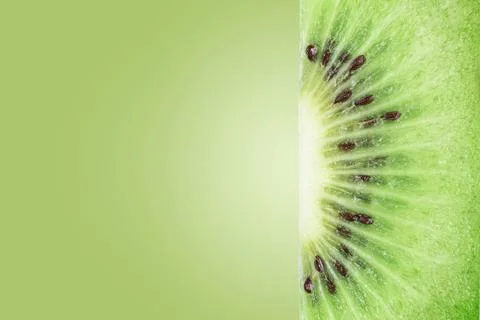 The texture of the cut kiwi on a green background with copies of space. Stock Photos