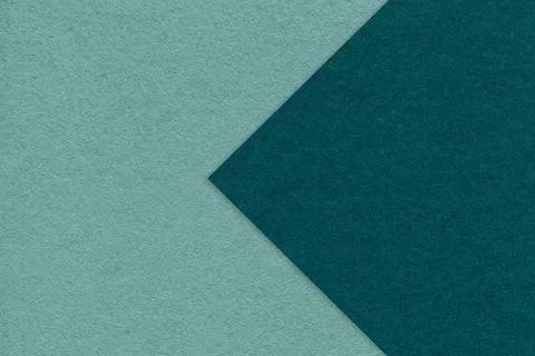 Texture of cyan paper background, half two colors with emerald arrow, macro. Foto stock