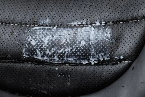 Texture of damaged black leather office chair, closeup Stock Photos