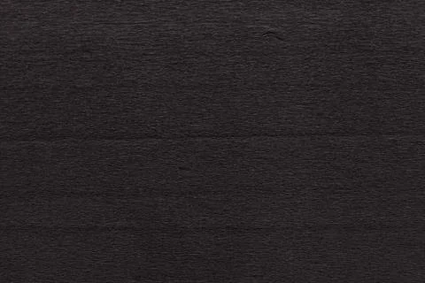 Texture of dark black corrugated thin uneven paper Stock Photos