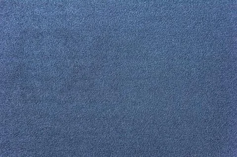 Texture of a dark blue carpet. Close-up of gradient light Stock Photos