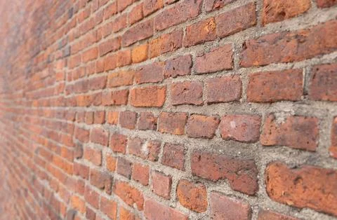 Texture dark brick wall of old castle, ancient red stone background. Stock Photos
