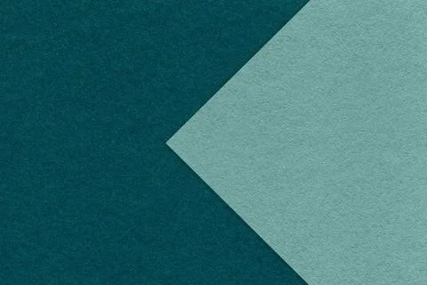 Texture of dark emerald paper background, half two colors with cyan arrow, macro Foto stock
