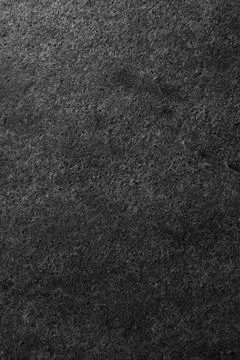 Texture of dark grey stone surface as background, closeup Stockfoto's