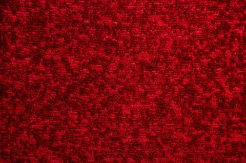 Texture of a dark red carpet. Close-up of gradient light Stock Photos