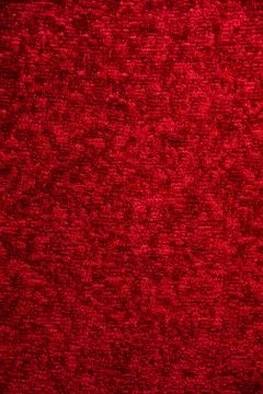 Texture of a dark red carpet. Close-up of gradient light Stock Photos