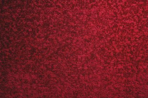 Texture of a dark red carpet. Close-up of gradient light Stock Photos