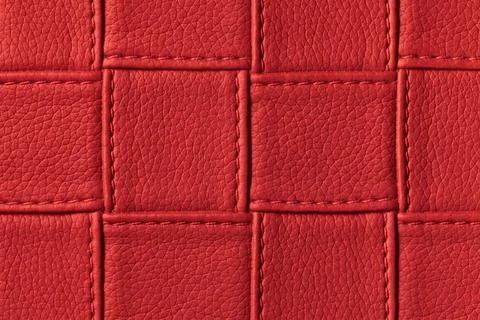 Texture of dark red leather background with square pattern and stitch, macro. Foto stock