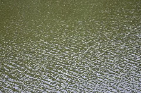 The texture of dark river water under the influence of wind, imprinted in per Stock Photos