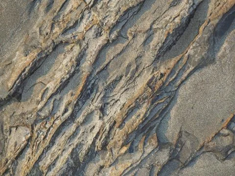 Texture of dark rock washed by waves in the morning Stock Photos