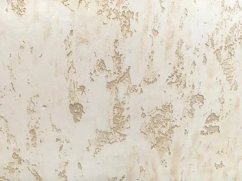 Texture decorative beige plaster imitating the old peeling wall. Stock Photos