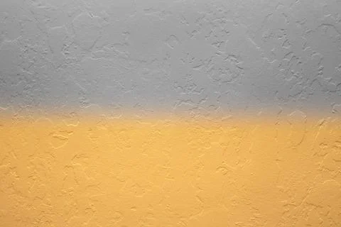 Texture of decorative plaster of gray and yellow color with a gradient on the Stock Photos
