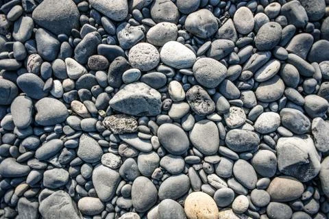 Texture with different sized stones lying on the beach in Iceland Stock Photos