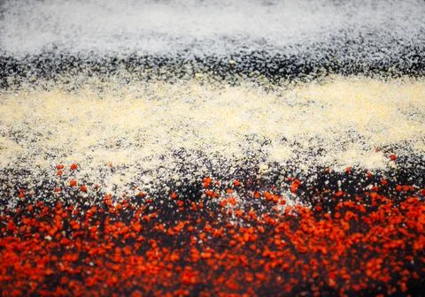 Texture of different spices on a black background . Stock Photos