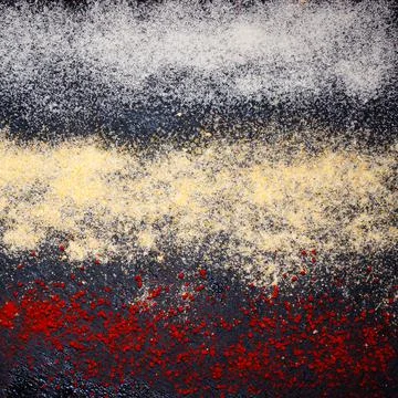 Texture of different spices on a black background . Stock Photos