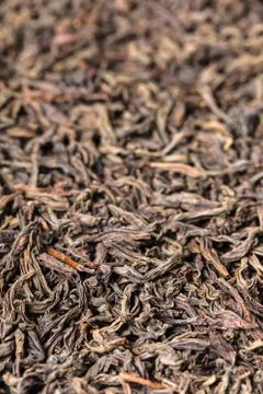 Texture of dry black large leaf tea Stock Photos