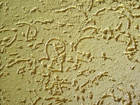 The texture of dry yellow plaster Stock Photos