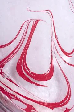 A texture of ebru technique with bright pink curving elements on the light su Illustrazione stock