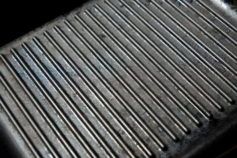 Texture of empty black cast heavy iron grill pan, modern kitchen equipment Stock Photos