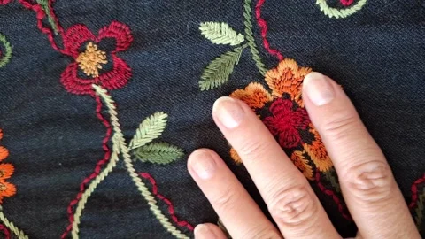 The texture of the fabric is dark blue with a floral pattern. Stock Footage 346492734