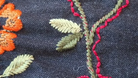 The texture of the fabric is dark blue with a floral pattern. Stock Footage 346492745